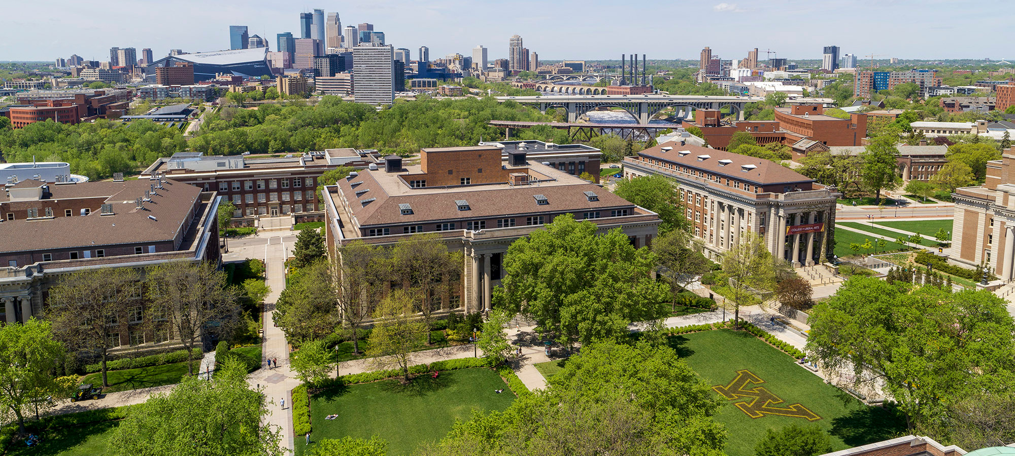 Aerial view of the East Bank campus mall with the Minneapolis skyline