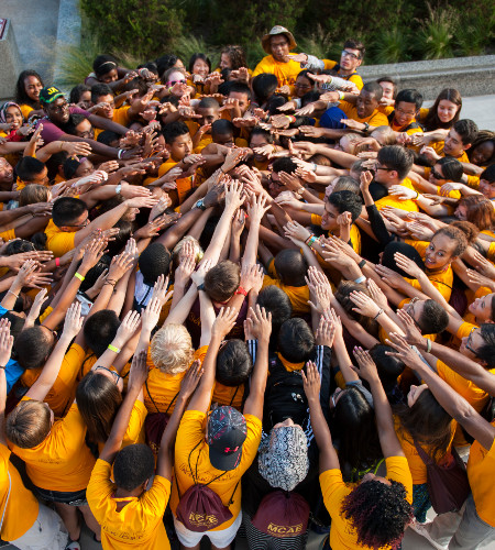 Students join hands in a giant circle