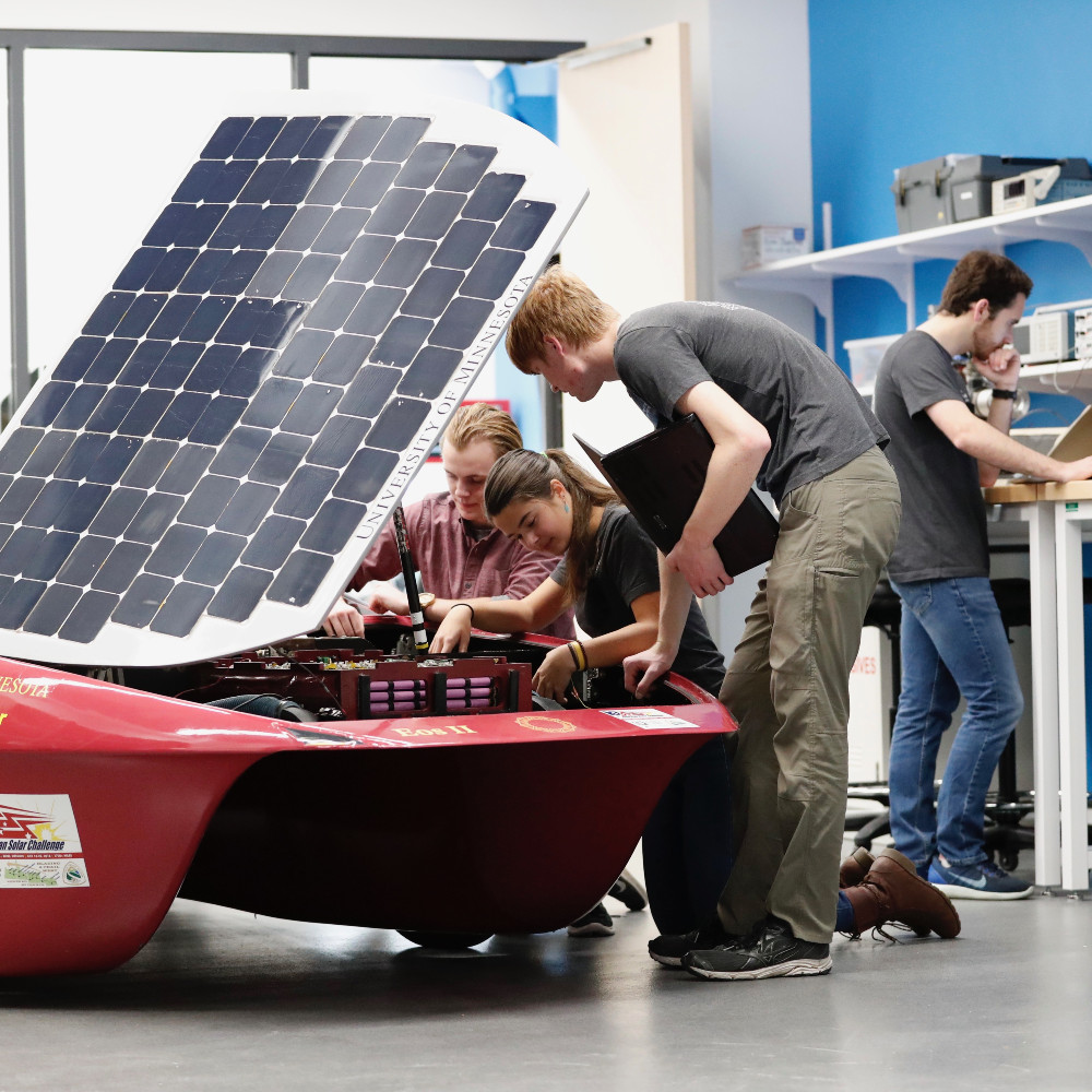 Students work on a solar paneled car
