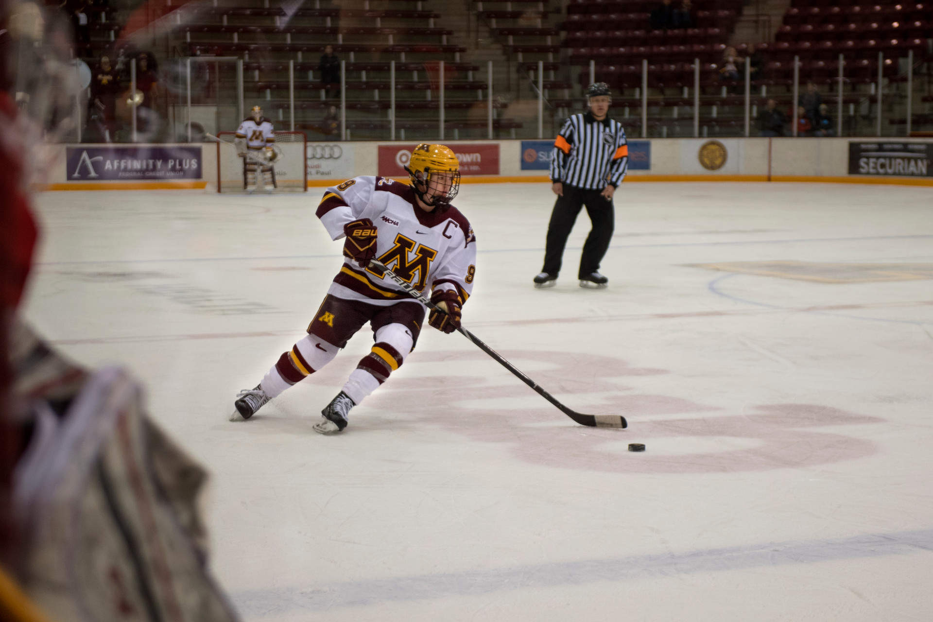 A U of M hockey player plays on the ice