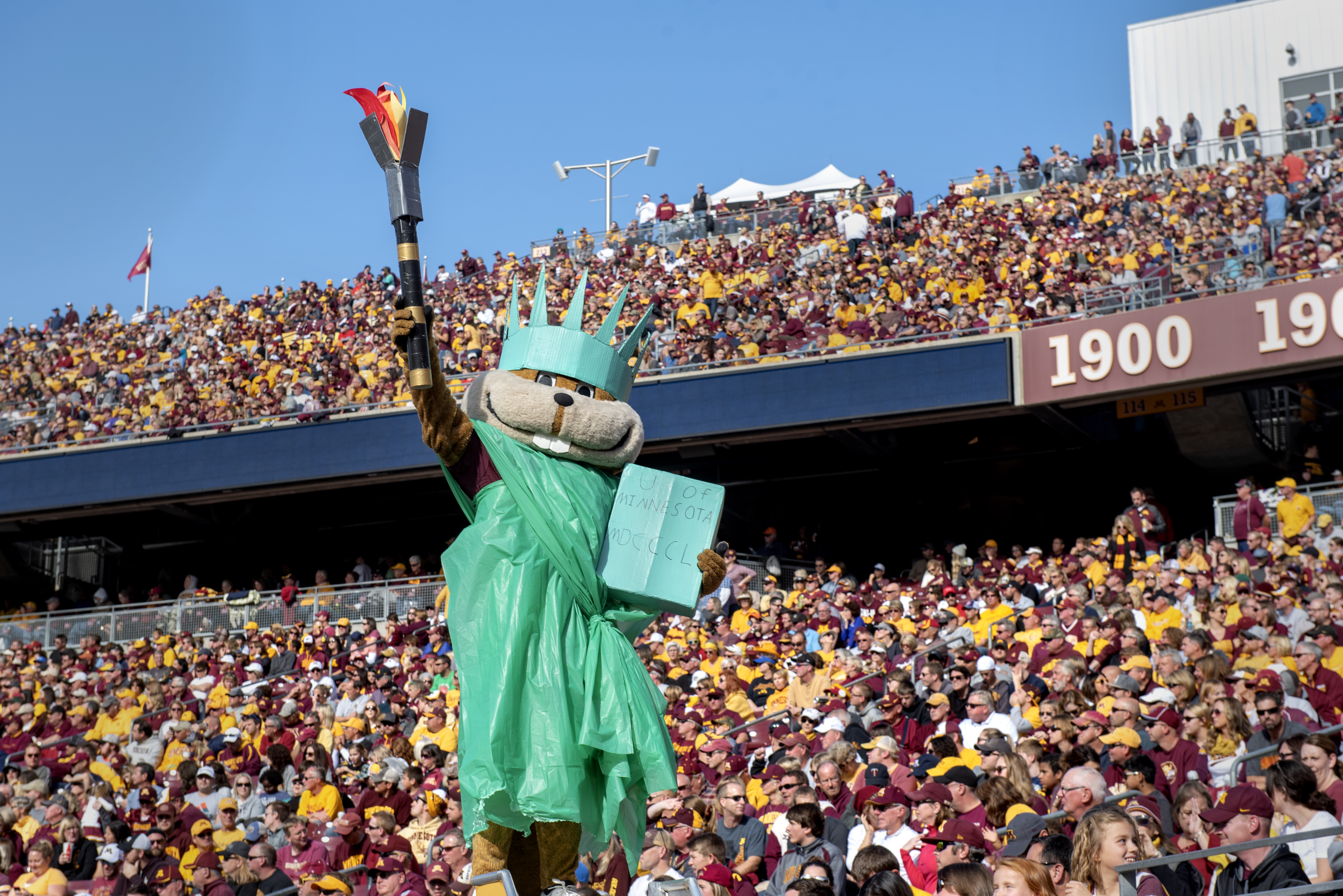 Goldy gopher mascot dressed in liberty costume at football game