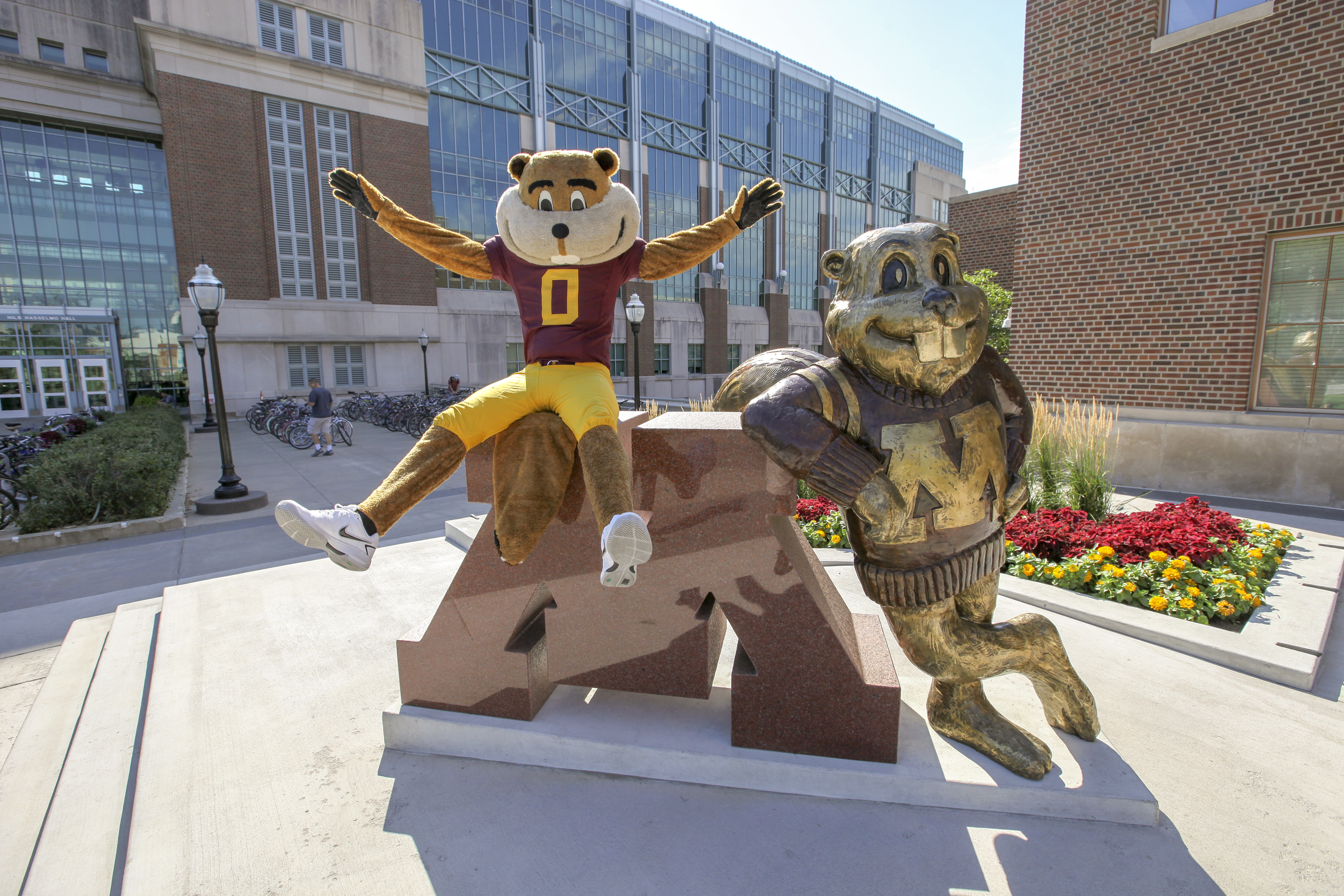 Goldy leaning on a statue