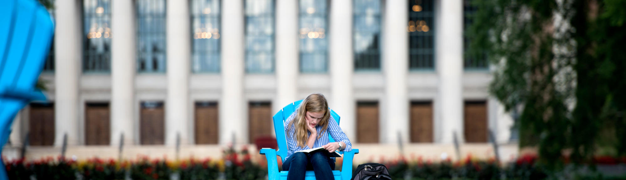 A student studies on the mall outside