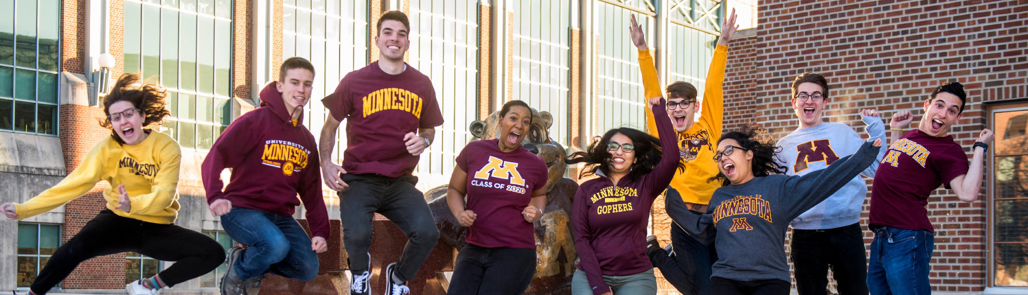 UMN Students jump in front of the Goldy Statue